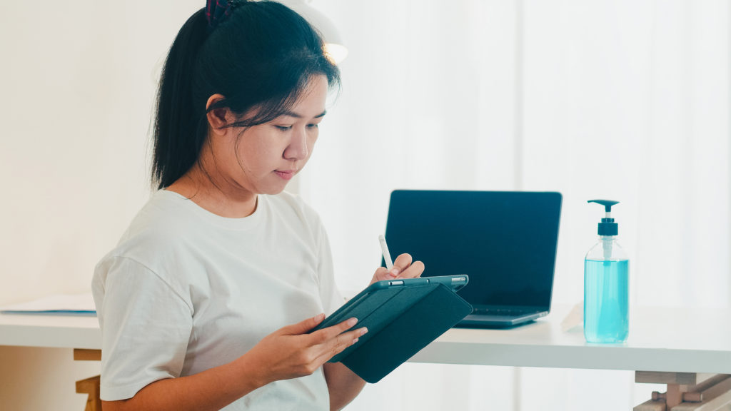 a girl writing on her tab